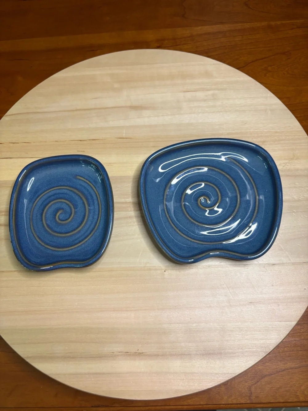 Pampered Chef Nesting Spoon Rest Set featuring a blue glaze with a swirl design.